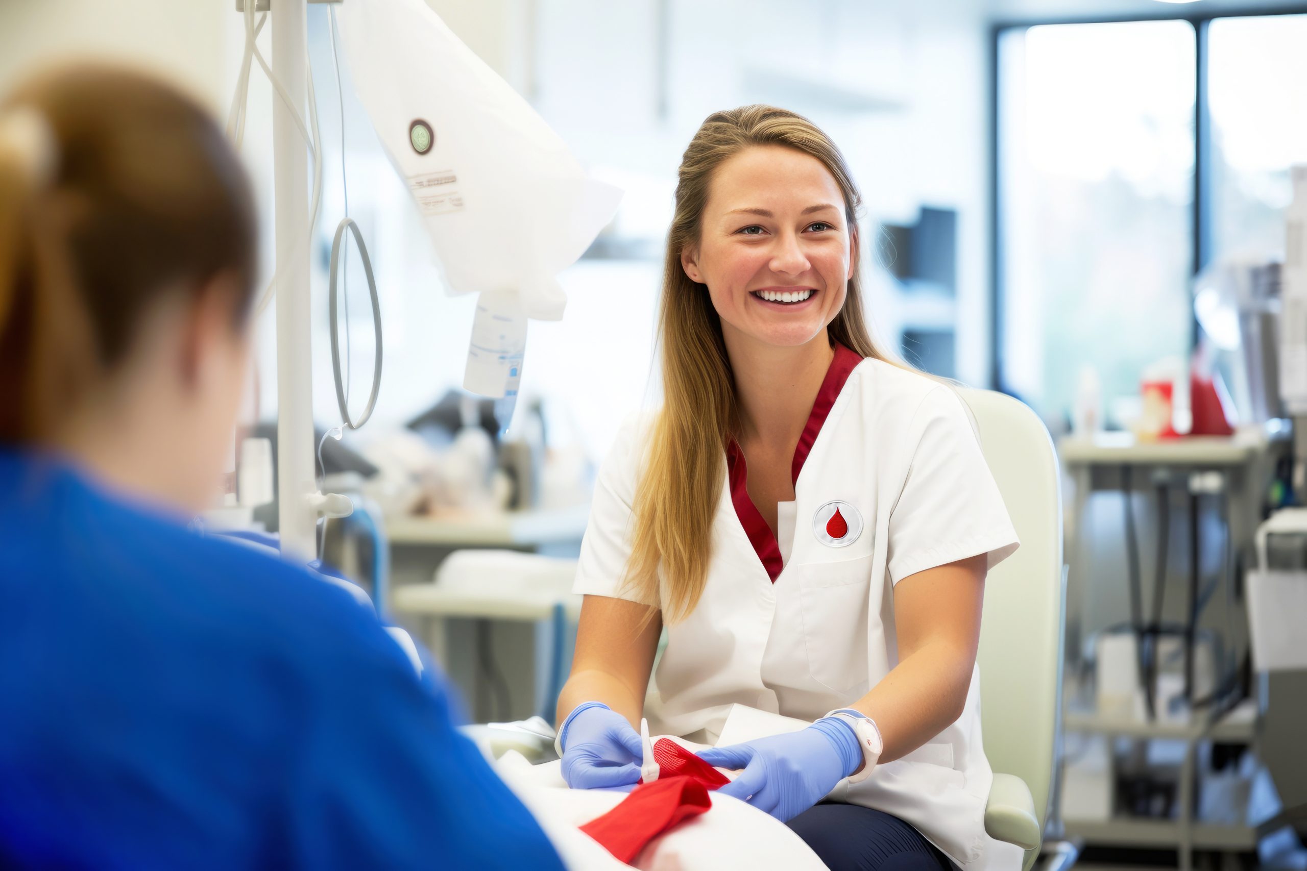 A smiling nurse draws blood from a volunteers donor in a modern clinic, blood collection. World donor day concept, national blood donor month