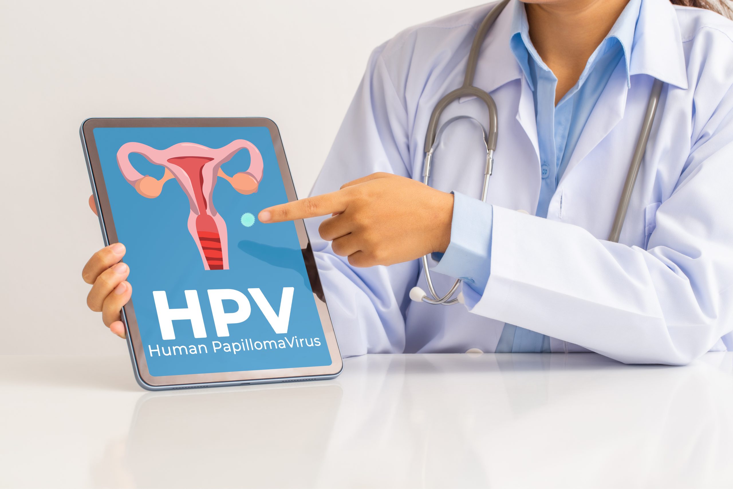 HPV (Human Papillomavirus) Female doctor explaining knowledge and pointed out women health problems on tablet screen, viruses Some strains infect genitals and can cause cervical cancer. HPV